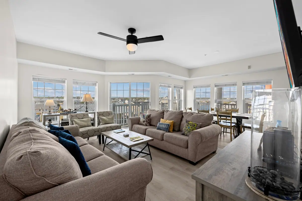Spacious living room with gray sofas and a wall of windows