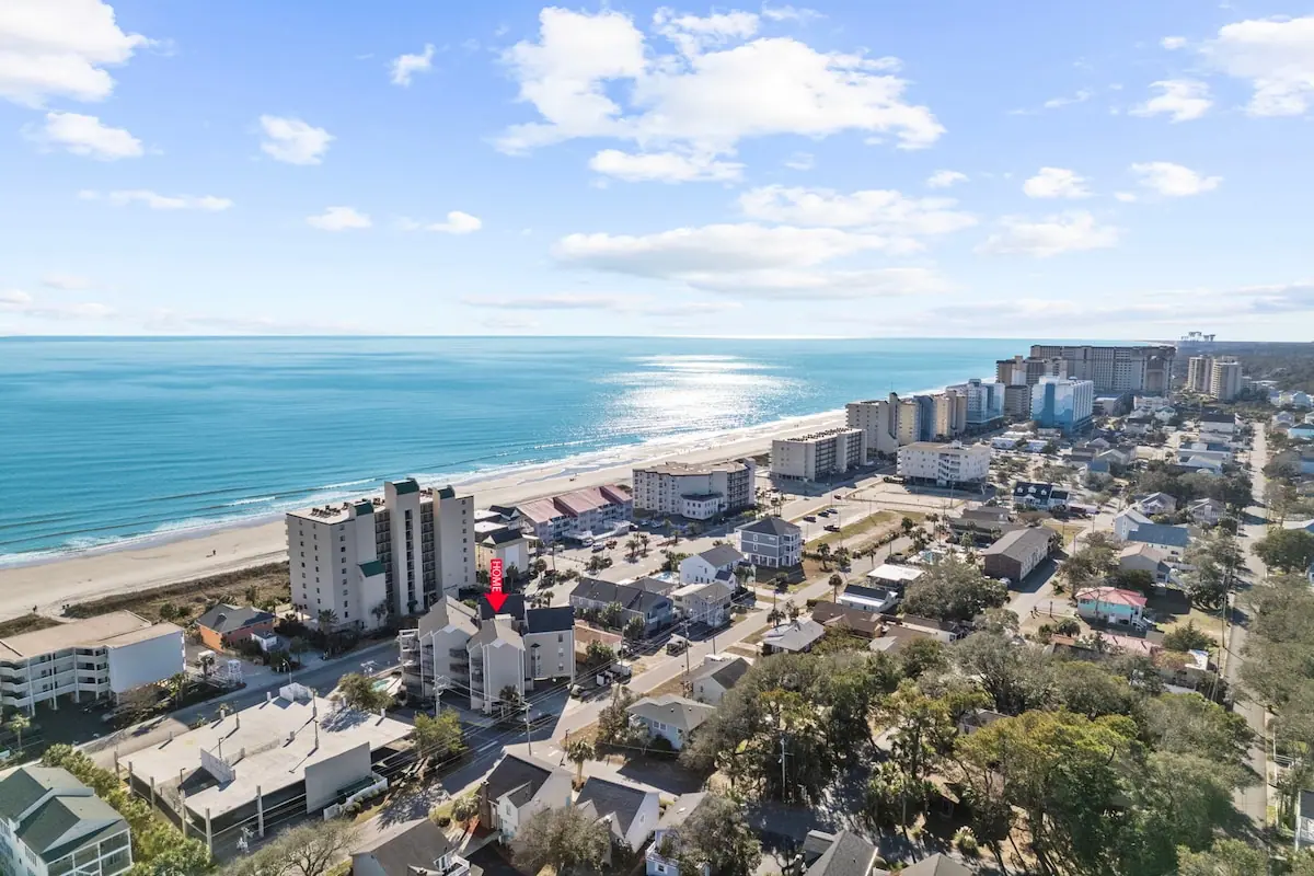 Aerial view of the coastline with beachfront buildings and the ocean